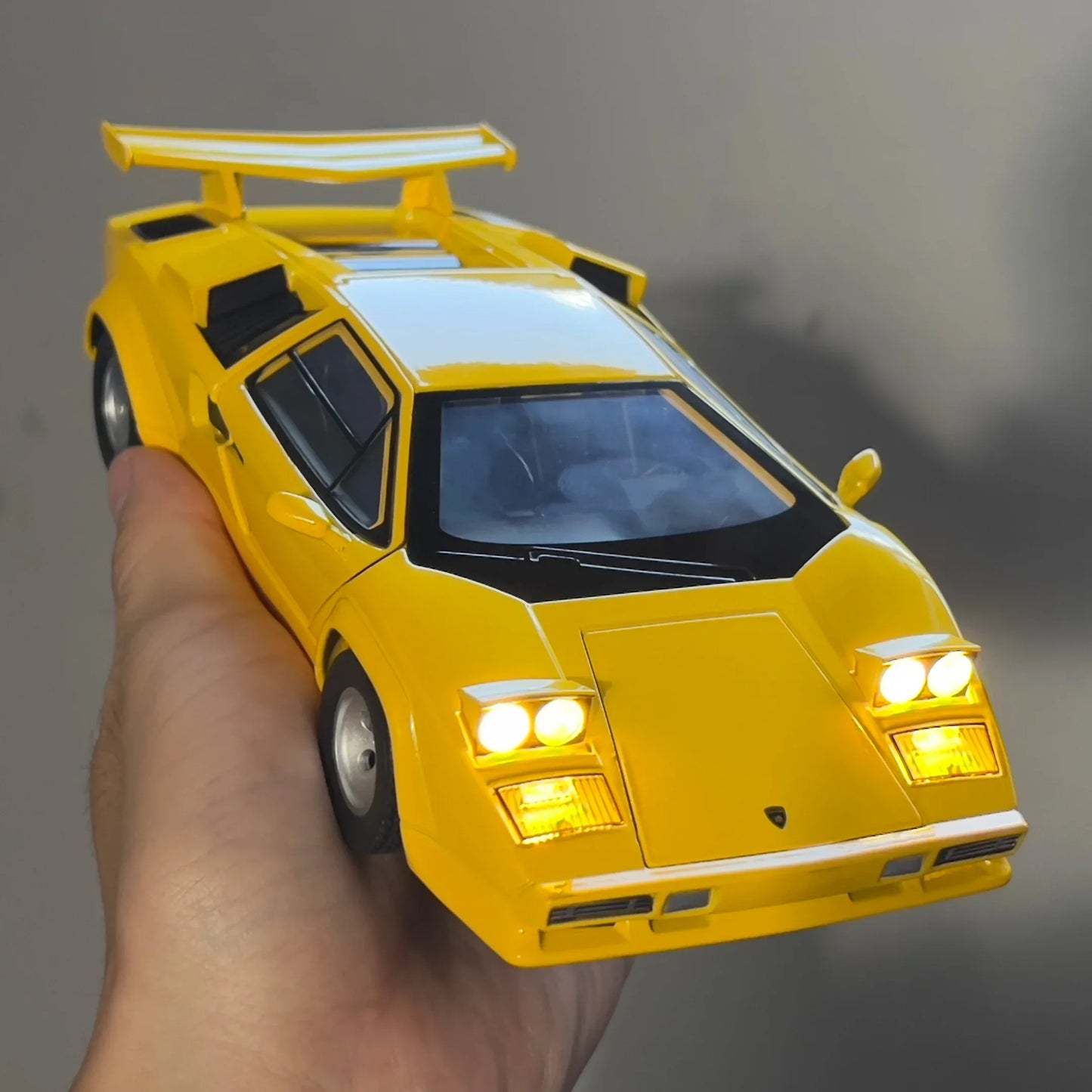 Yellow Lamborghini model car with detailed features and working lights.